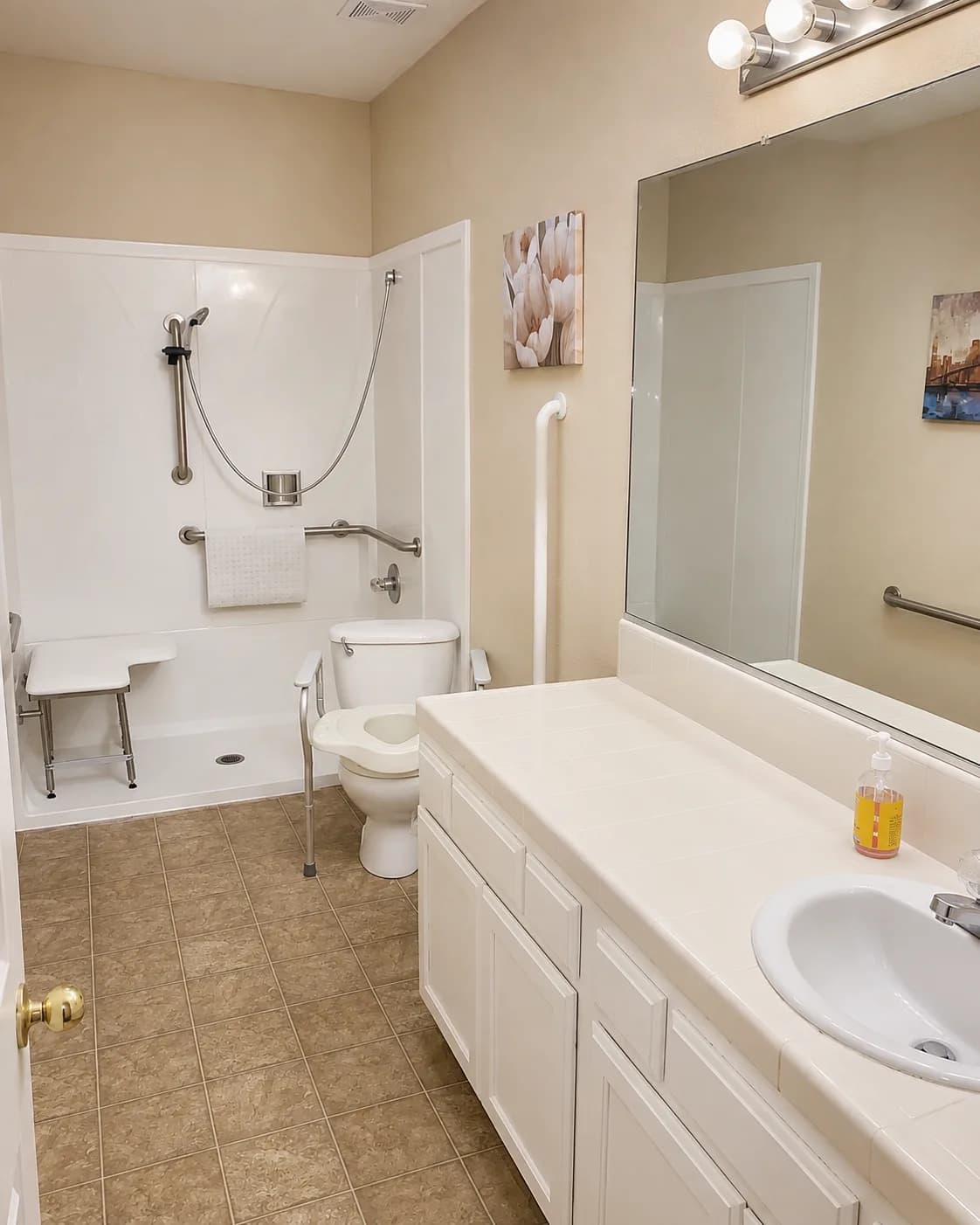 Accessible bathroom at Joy in Caring I with grab bars, a roll-in shower and shower seat